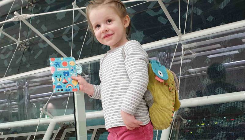 Little girl with Petit Collage passport holder