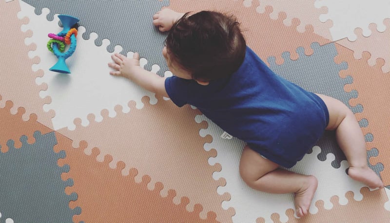 Baby crawling on the Skip Hop Playspots Foam Floor Tiles